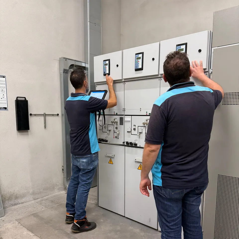 Due tecnici CHECKS controllano un quadro elettrico con un tablet